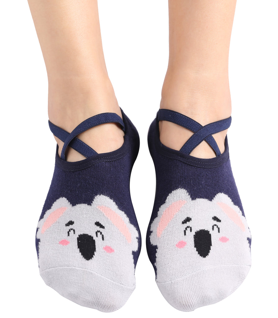 Person wearing navy blue socks with cute koala face design and crisscross straps.