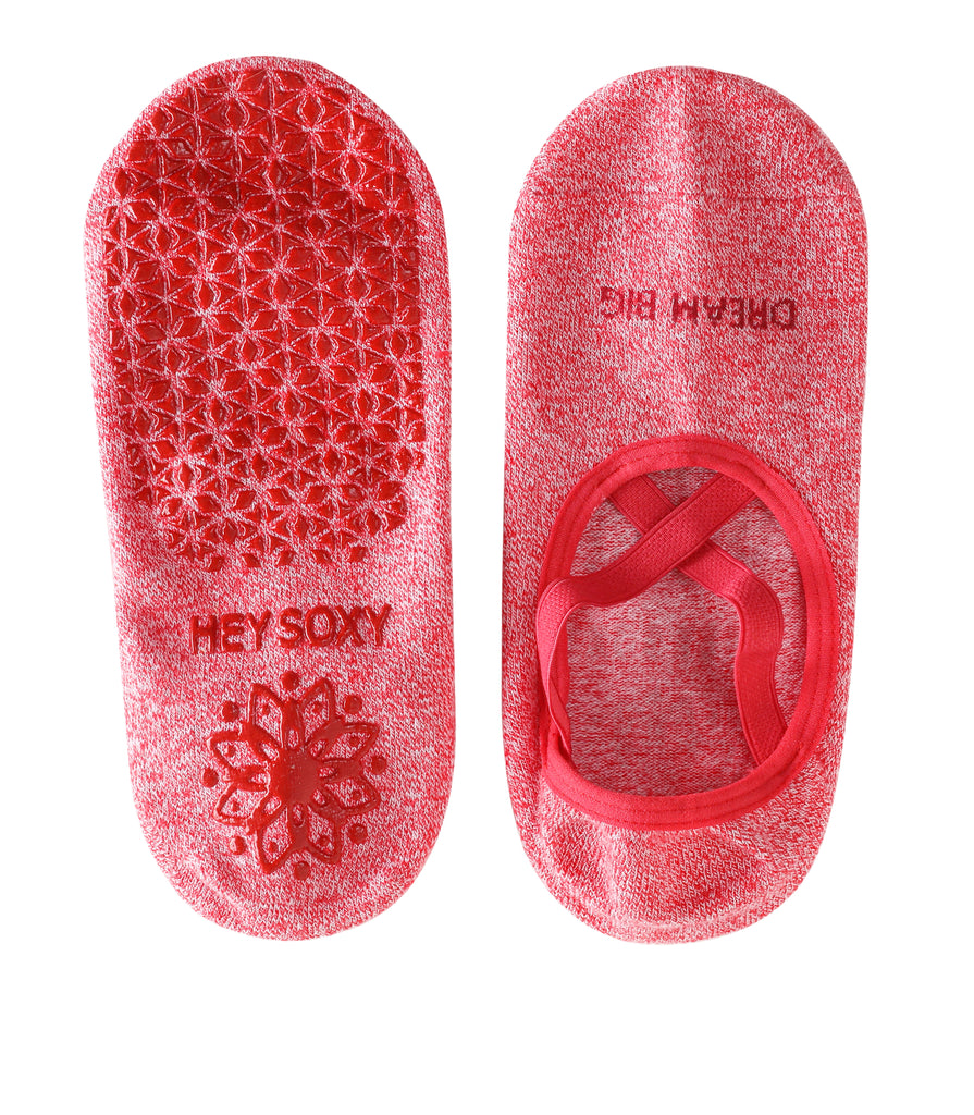 Red anti-slip yoga socks with criss-cross design and grip soles labeled "Hey Soxy".