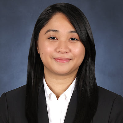 Person wearing a black blazer over a white shirt against a blue background