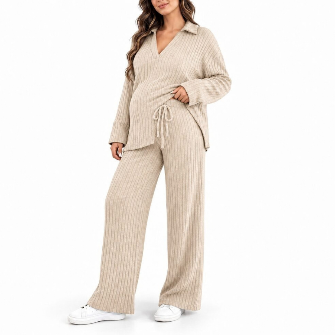 Pregnant model wearing a beige ribbed knit maternity lounge set with a V-neck top, drawstring waist, and wide-leg pants.