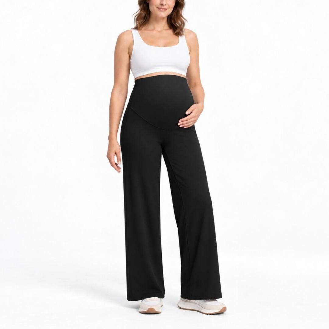 Front view of a model wearing black wide leg maternity pants.