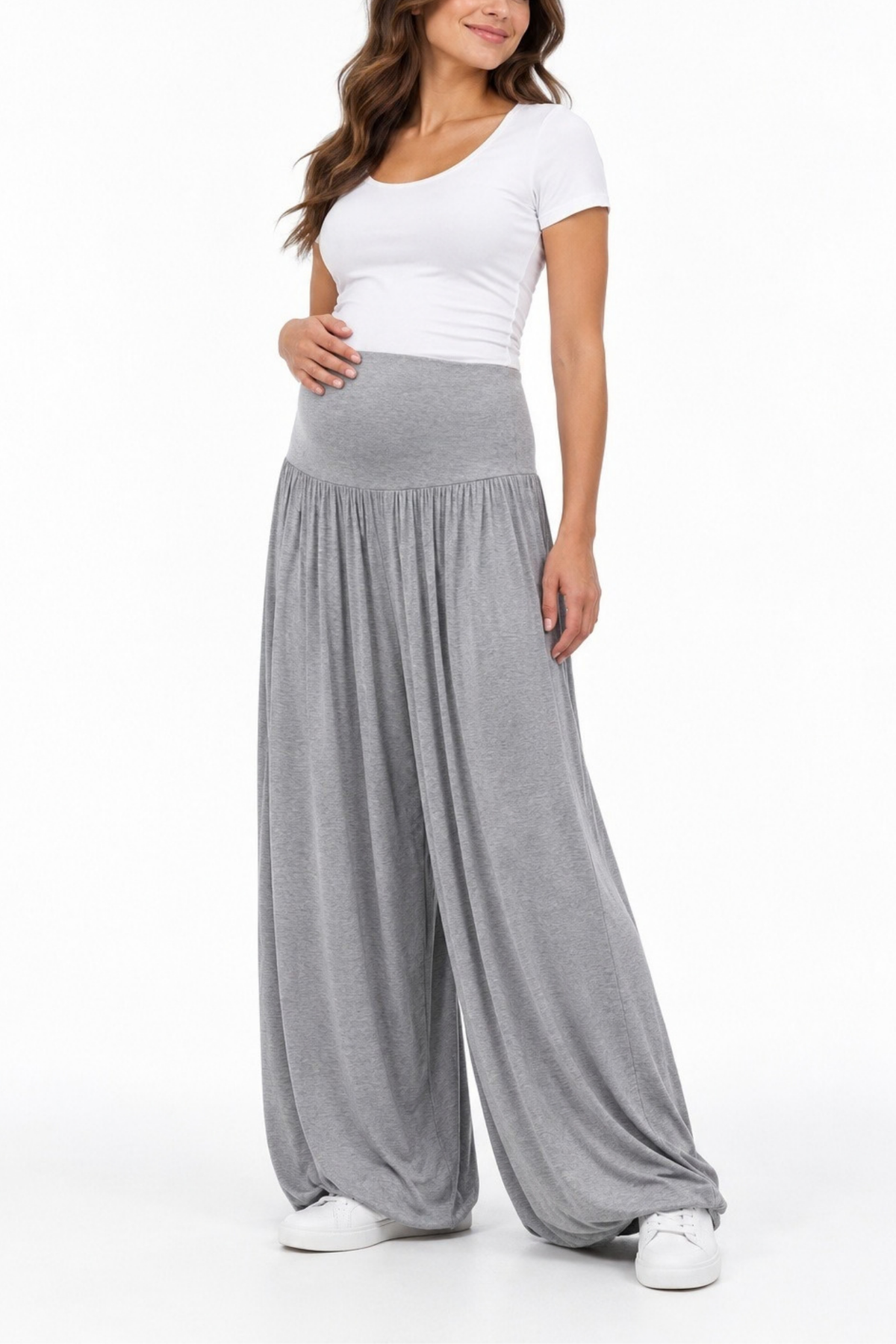 Angled front view of a pregnant model wearing gray maternity wide-leg pants with a gathered waistband and white fitted top.