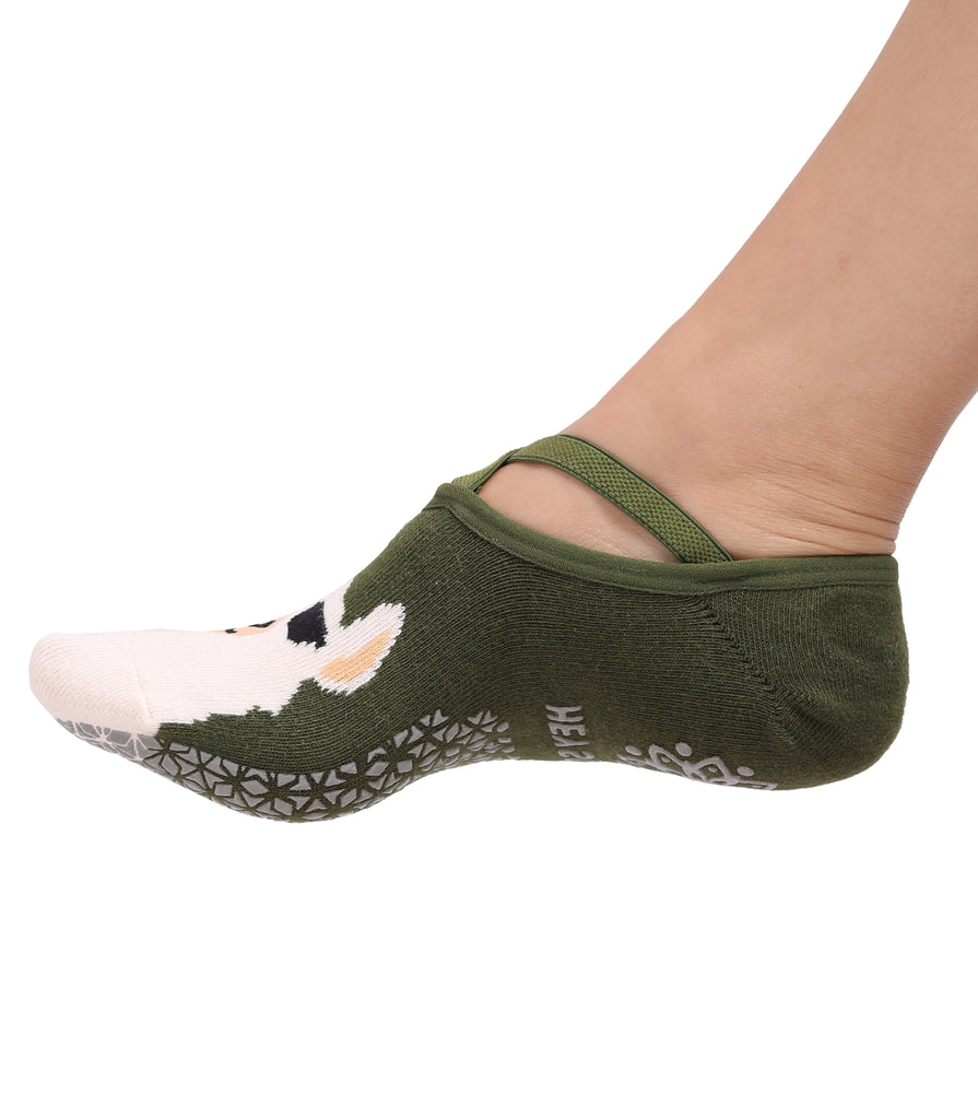 Green no-show sock with a dog illustration and non-slip grip sole on a person's foot.