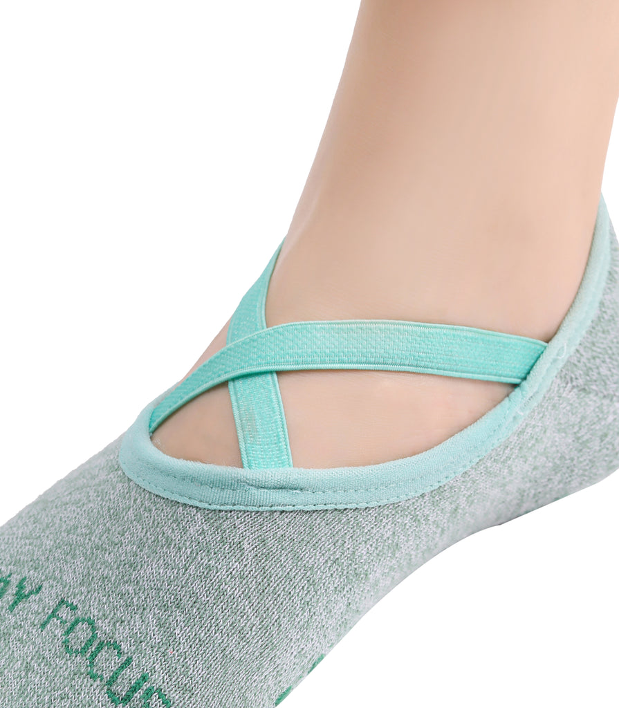 Gray and teal ballet-style yoga sock with criss-cross elastic straps on foot.