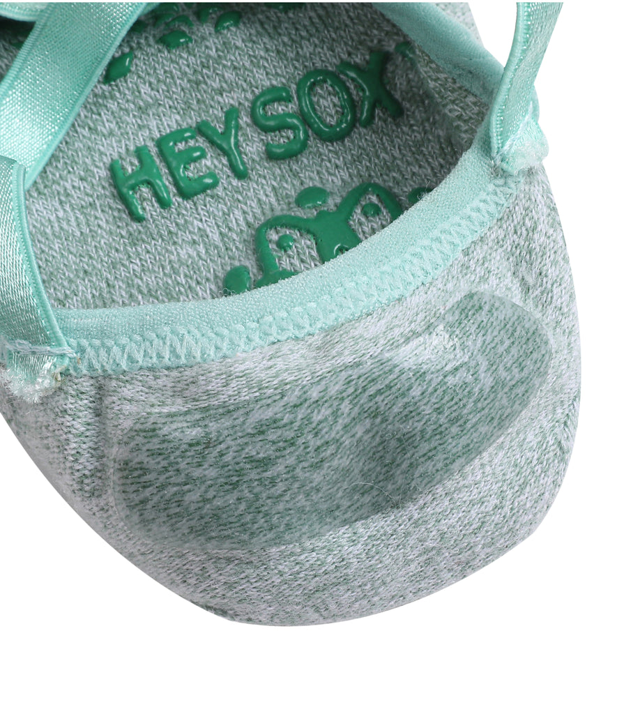 Close-up of a grey and mint green shoe with textured fabric and strap, featuring the text HEYSOX engraved inside.