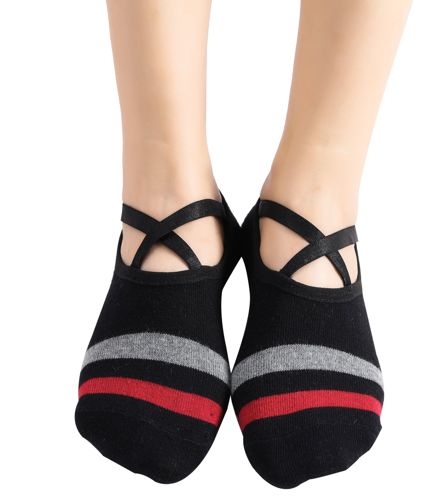 Black ballet socks with criss-cross straps and red and gray stripes on feet.
