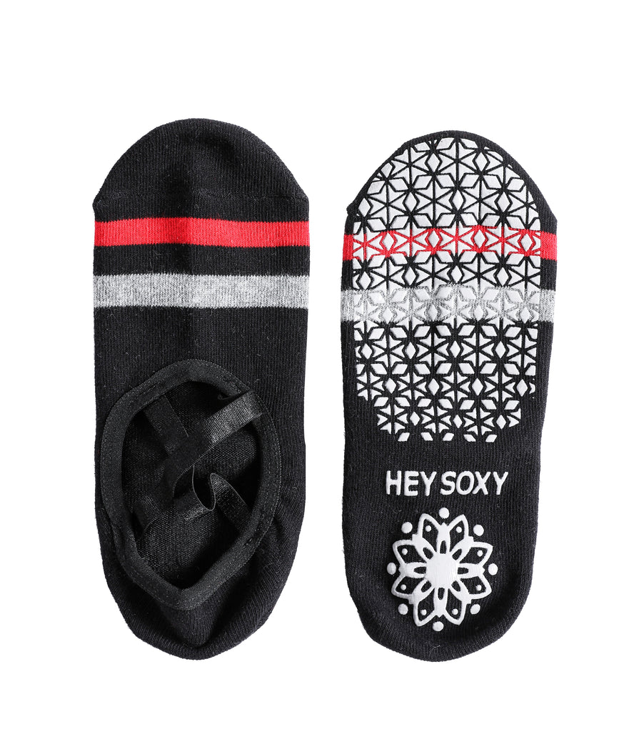 Black yoga socks with grip dots and white geometric design, red and gray stripes.