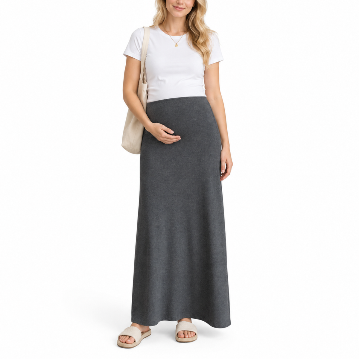 Pregnant woman wearing a charcoal gray maternity maxi skirt with an over belly waistband in a full front view.