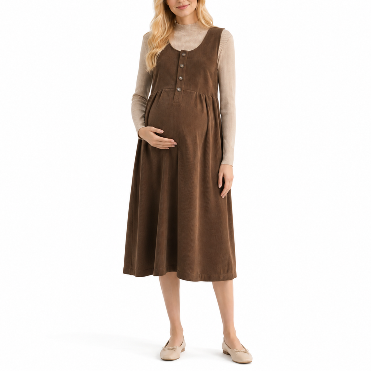 Pregnant model wearing a coffee brown sleeveless maternity pinafore dress with a relaxed A-line silhouette and button-front detail, layered over a long-sleeve top.