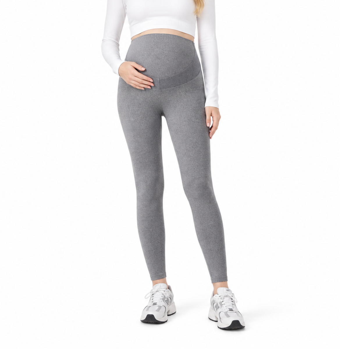 Pregnant woman wearing dark gray full-length maternity leggings with a high-rise over belly waistband.