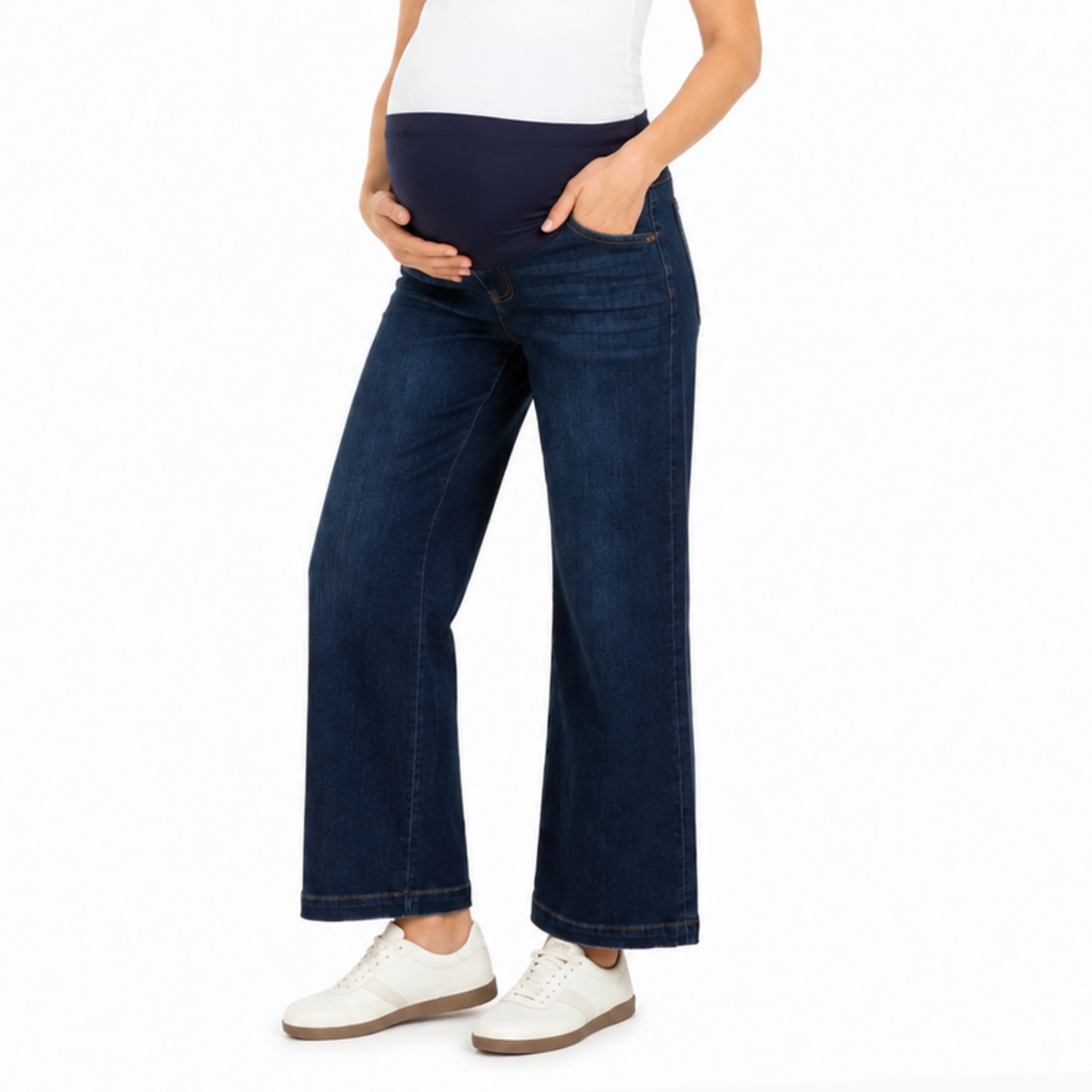 Pregnant woman wearing dark wash cropped wide leg maternity jeans with a comfortable over belly waistband and functional pockets.