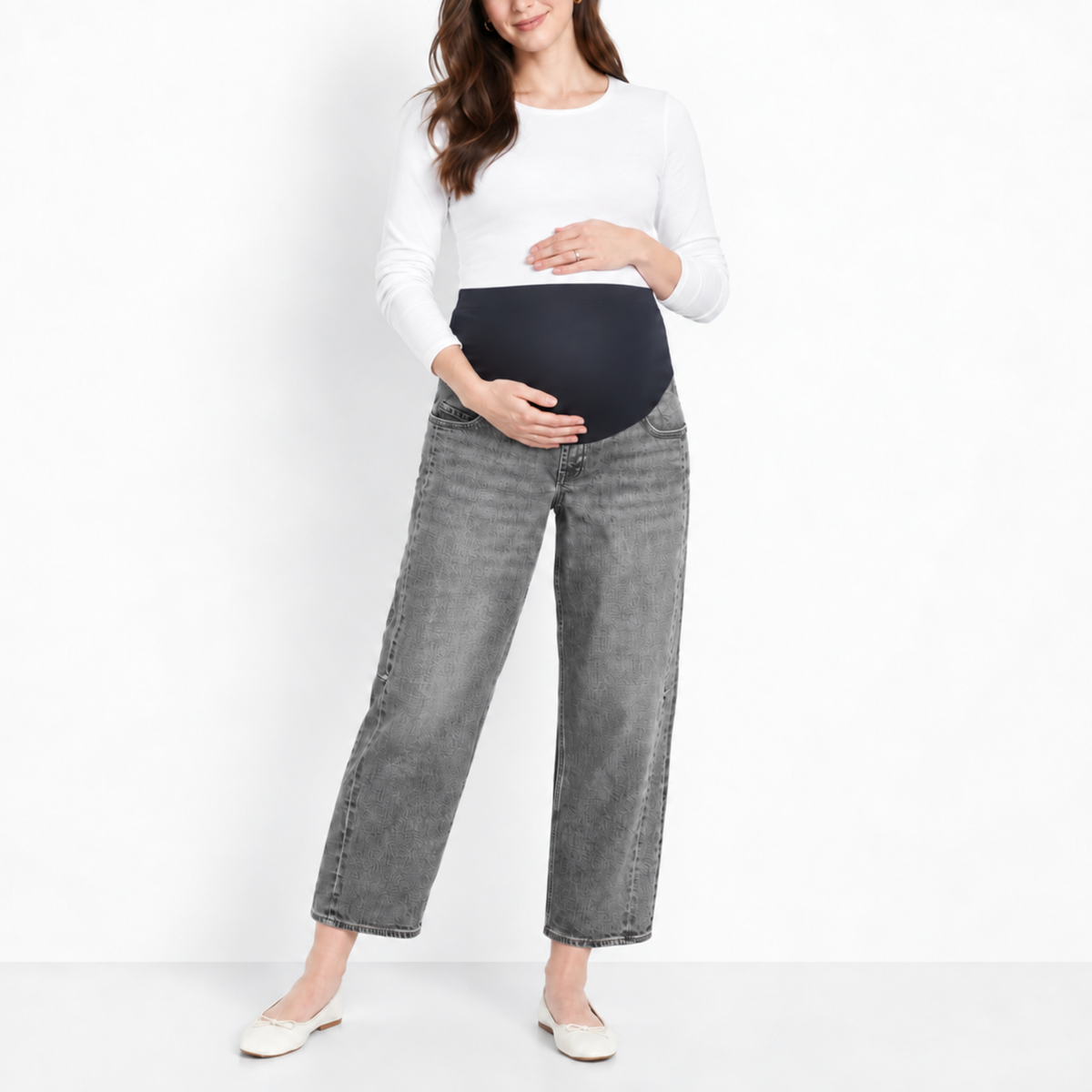 Pregnant woman wearing graphite gray maternity ankle jeans with a full over belly panel and relaxed cropped-leg silhouette.