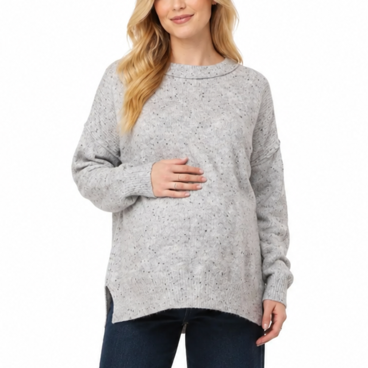 Pregnant model wearing a gray maternity sweater with a relaxed bump-friendly fit, shown from the front.