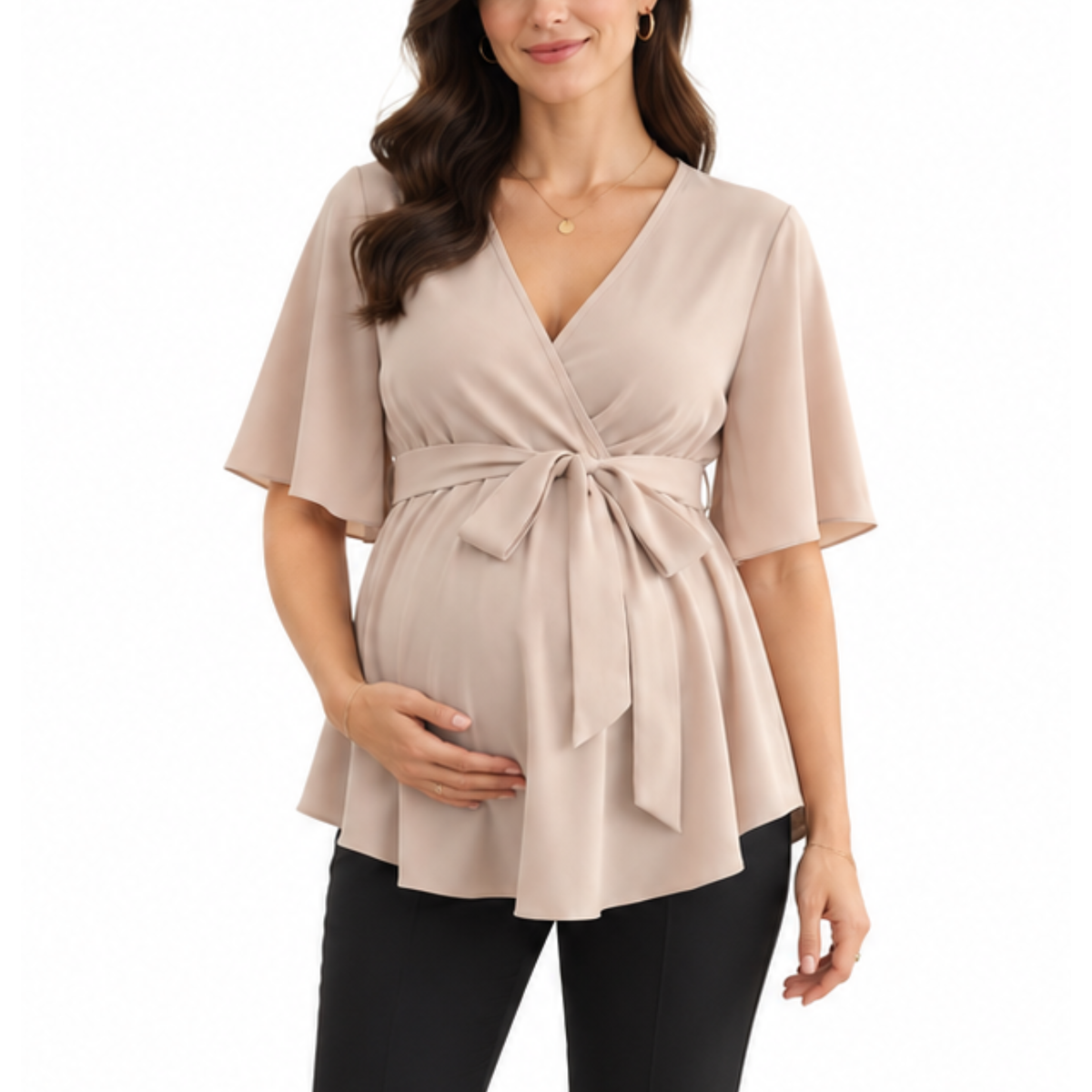 Pregnant woman wearing a light beige maternity blouse with a wrap-style V-neckline, self-tie waist, and flowing hem.
