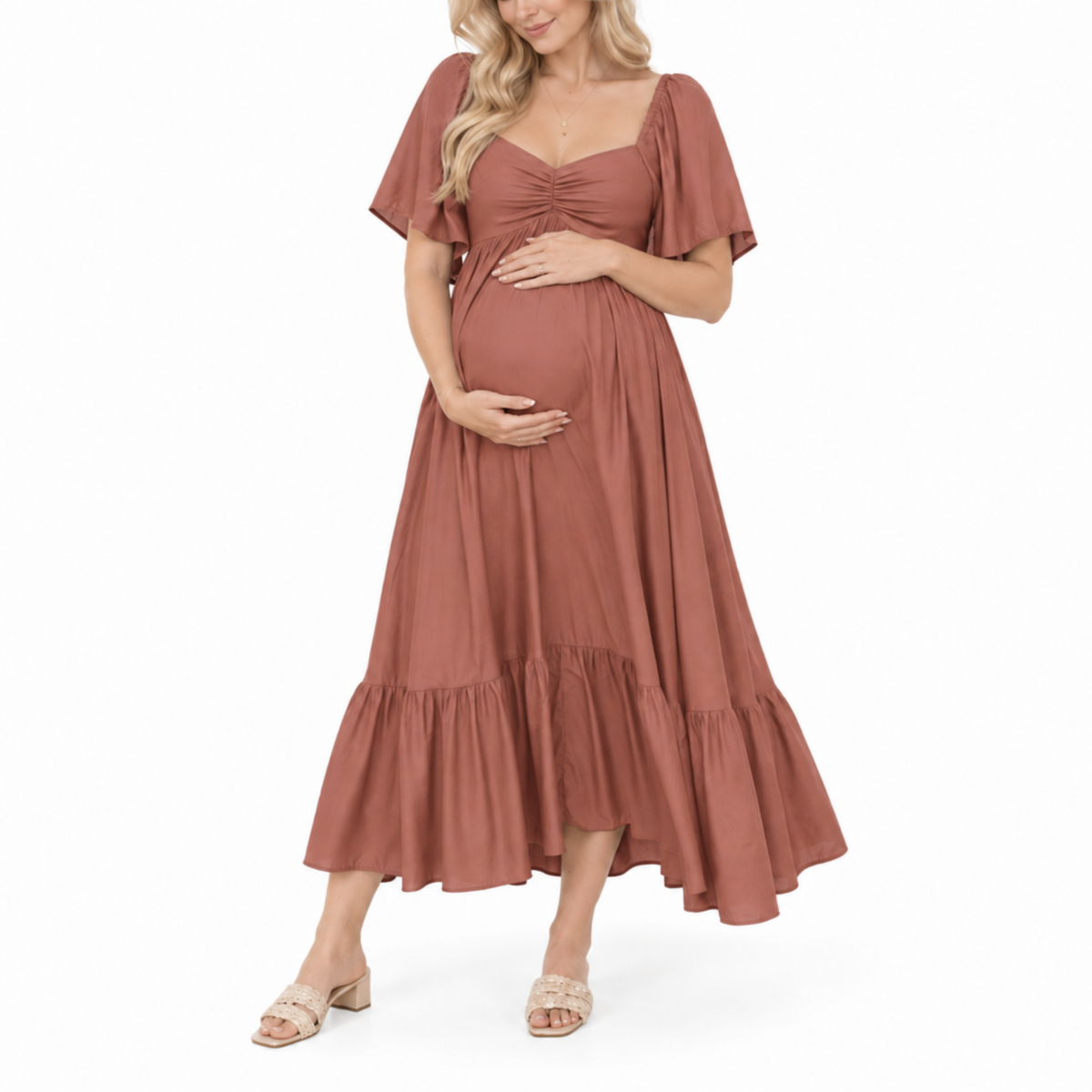 Pregnant woman wearing a rust maternity midi dress with a sweetheart neckline, flutter sleeves, and a flowing skirt.